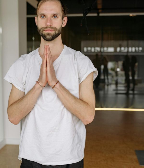 Person practicing calm rhythmic yoga breathing in a dark studio